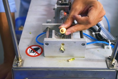 只要將蓮子黑頭對準半自動蓮子去芯機的凹槽，置於V型枕中，按下按鈕就可自動去芯。（攝影／潘子祁）