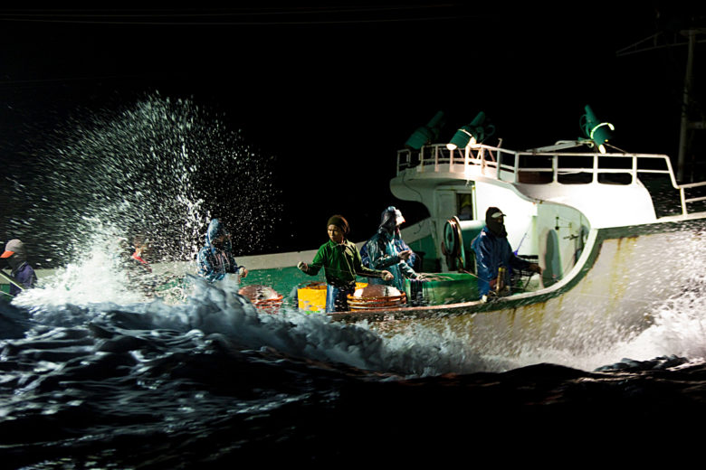 Crew from the fishing vessel Jia Yu Fa pull in a longline at night. Two Taiwanese longline ships, Her Hae and Jia Yu Fa, are caught on camera by Greenpeace illegally transferring fish at sea. The transfer of fish at sea is one of the methods used around the world to cover up illegal, unreported and unregulated (IUU or pirate) fishing activities. Globally, more than US$9 billion is lost annually to pirate fishing fleets which claim their profits in European, American and Asian markets, depriving coastal communities of millions of dollars of much-needed income.